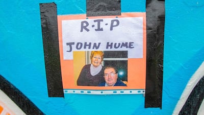 A photograph and message is pictured at the Free Derry wall in the Bogside area for John Hume in Derry. AFP