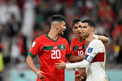 Cristiano Ronaldo is consoled by Morocco's Achraf Dari and Jawad El Yamiq after Portugal's World Cup exit. AFP