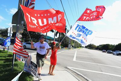 Supporters of President Donald Trump rally in front of the polling location at the Wellington Brand Library. AFP