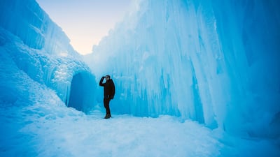 A visitor explores caverns and tunnels of the Ice Castles in North Woodstock, New Hampshire. AFP