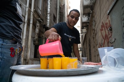 The charity iftars are no longer being held in large tents but rather in smaller side streets and alleys. Mahmoud Nasr / The National