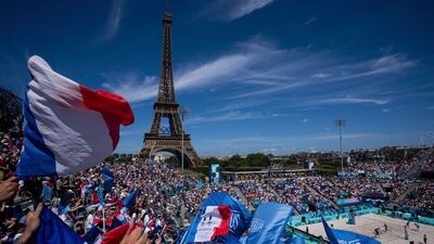 French supporters wave flags during the women's pool C beach volleyball match between Germany and France at Eiffel Tower Stadium at the 2024 Summer Olympics in Paris. AP
