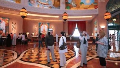 Guests arrive at The Atlantis: many of the wealthy booked and paid for their holidays before the global economy collapsed.