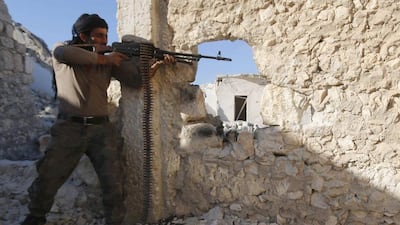 A Free Syrian Army fighter fires his weapon during clashes with forces loyal to Syria's president Bashar Al Assad in the Handarat area, north of Aleppo on November 6. Reuters