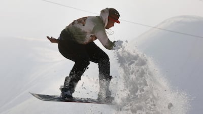 An Afghan snowboarder performs during a practice session on a snow-covered hilltop in Kabul. EPA