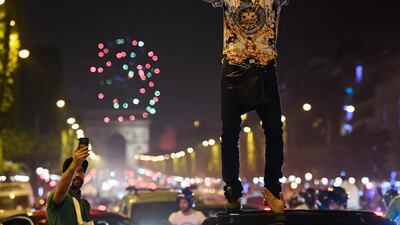 Algeria's supporters celebrate in front of the Arc de Triomphe. AFP