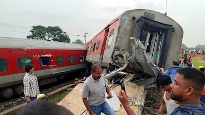 People gather at the site of the Howara-CSMT Express train derailment near Badabamboo, in Jharkhand, India. EPA