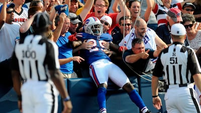 Buffalo Bills cornerback Drayton Florence jumps into the stands to celebrate an interception and touchdown against the New England Patriots in the fourth quarter of their NFL football game in Orchard Park, New York September 25, 2011. Doug Benz / Reuters
