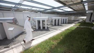 A Dewa employee walks near the solar water heater and the green roof system at Dewa’s new Sustainable Building in Al Quoz. Jaime Puebla / The National