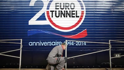 An employee works next to a Eurotunnel freight train at the Channel tunnel maintenance center in Coquelles, near Calais. Christian Hartmann / Reuters