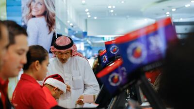 Thousands of passengers thronged the aisles of Dubai Duty Free on Saturday as the retailer slashed prices by as much as 25 per cent on the busiest weekend of the year. Victor Besa for The National