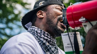 A man speaks in to a microphone to demonstrators at a pro-police rally on June 27 in St Paul, Minnesota, US. Brandon Bell / Getty Images/ AFP