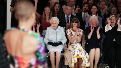 Britain's Queen Elizabeth II, 91, wore black gloves for her first-ever London Fashion Week front row appearance. Reuters