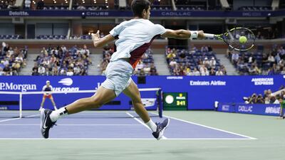 Carlos Alcaraz returns to Jannik Sinner during their US Open quarterfinal match. Getty