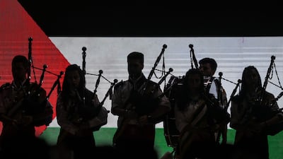 Palestinians play the bagpipes to mark the occasion. EPA