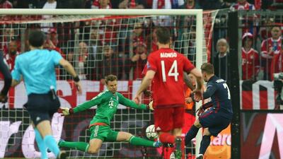 Atletico Madrid striker Antoine Griezmann scores the equaliser against Bayern Munich. Michaela Rehle / Reuters