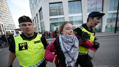 Swedish climate campaigner Greta Thunberg is removed by police from outside Malmo Arena during a pro-Palestine rally during the 68th Eurovision Song Contest in Malmo. EPA