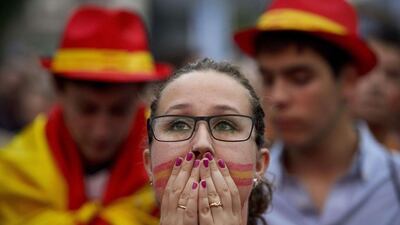 A Spain fan watches the 2014 World Cup Group B match on Wednesday against Chile on a screen in Madrid, Spain. Dani Pozo / AFP