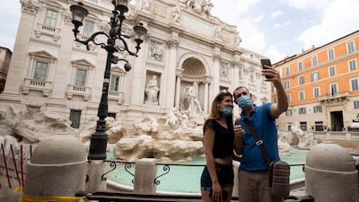 Tourists take a selfie in front of Trevi Fountain during phase 2 of the COVID-19 coronavirus emergency in Rome, Italy, 18 May 2020 EPA