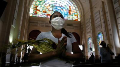 A woman attends Palm Sunday Mass in Caacupe, Paraguay. AP Photo