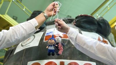 At the Baikonur Cosmodrome in Kazakhstan, Expedition 52-53 crewmembers display toys from their children in front of the Soyuz MS-05 spacecraft. The toys are hung above the crew members’ heads to act as 'zero-g indicators'. Andrey Shelepin / Gagarin Cosmonaut Training Centre