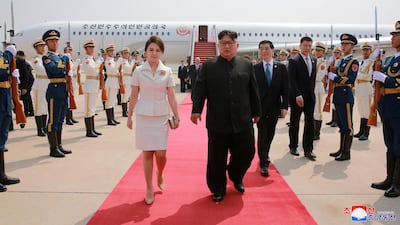 North Korean leader Kim Jong-un and his wife Ri Sol-ju arrive in Beijing, China. KCNA via Reuters