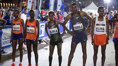 Participants warming up before the race at the Adnoc Abu Dhabi Marathon. Leslie Pableo for The National
