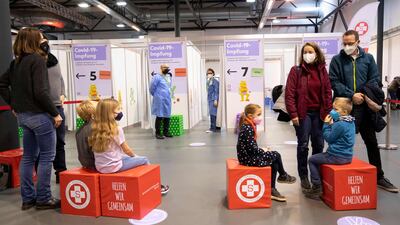 Children wait in line to receive their first dose of the Covid-19 vaccine in Vienna. AFP