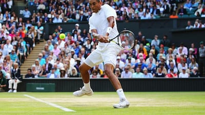 Nick Kyrgios of Australia plays a backhand return during his singles match against Rafael Nadal on Tuesday at the 2014 Wimbledon Championships. Al Bello / Getty Images