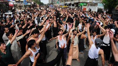 Pakistani Shia Muslims beat their chests during a religious procession marking Ashura in Karachi. (Asif Hassan / AFP)