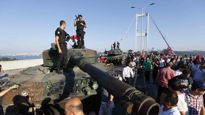 Policemen stand on a military vehicle after troops involved in the coup surrendered on the Bosphorus Bridge in Istanbul, Turkey July 16, 2016. Murad Sezer / Reuters
