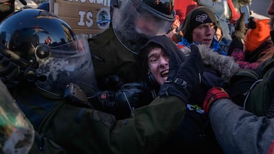 A demonstrator confronts police. AFP