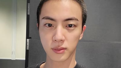 Jin sports a buzz cut before the start of his conscription. AP