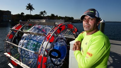 Reza Baluchi in Lake Park, Florida, with his seafaring vessel in 2016. AP