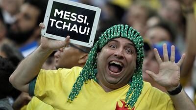 A Brazil fan holds a placard that reads 'goodbye Messi'. EPA