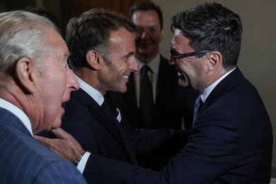 King Charles III, left, looks on as France's President Emmanuel Macron meets Britain's Prime Minister Andy Burnham in London. AFP