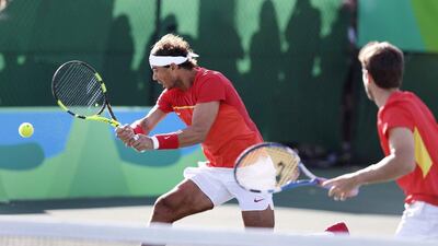 Rafael Nadal, of Spain, returns during a match with his partner Marc Lopez, right, against Canada during the men’s doubles at the 2016 Summer Olympics in Rio de Janeiro, Brazil, Thursday, August 11, 2016. Charles Krupa / AP Photo