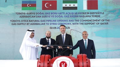 Turkey's Energy Minister Alparslan Bayraktar, second right, Economy Minister Mikayil Jabbarov, right, Energy Minister Mohammed Al Bashir, second left, and director general of Qatar Fund for Development Fahad Hamad Hassan Al Sulait, left, at the opening of the Turkey-Syria natural gas pipeline in Kilis, Turkey. AFP