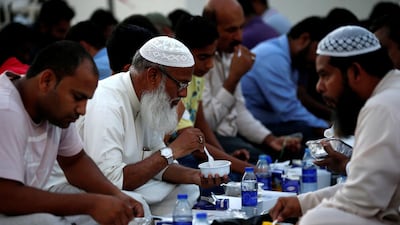 Muslims break their fast after sunset during Ramadan, in Dubai. Ali Haider / EPA