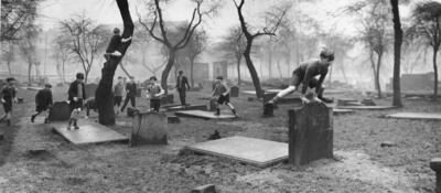 Children in Gorbals play among gravestones, a few years before the tale of the monster sent them on a vampire hunt. Getty Images