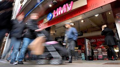 Shoppers walk past an HMV store on Oxford Street in central London. Ben Stansall / AFP