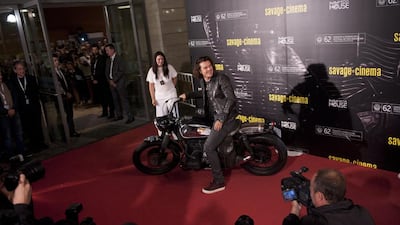 British actor Orlando Bloom arrives to the red carpet on a motorcycle to promote his film The Greasy Hands Preachers, at the 62nd San Sebastian Film Festival, in San Sebastian, northern Spain, Friday, September 26, 2014. The festival is one of the most prestigious and internationally recognised in Spain. AP