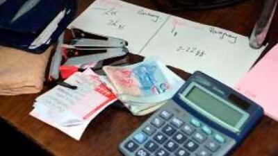 Interpol released this photo which shows betting records and cash that were seized in Singapore during an operation targeting illegal football gambling in Asia during the World Cup.