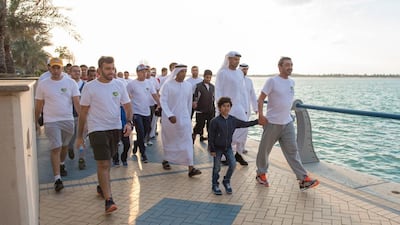 Sheikh Abdullah bin Zayed leads employees of the Ministry of Foreign Affairs and their families in a 7km walk along the Abu Dhabi corniche.