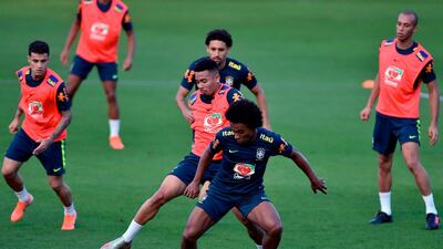 Brazil winger Willian shields the ball from Gabriel Jesus during a practice match. AFP