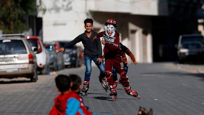 Palestinian children play with roller skates in Gaza City. AFP