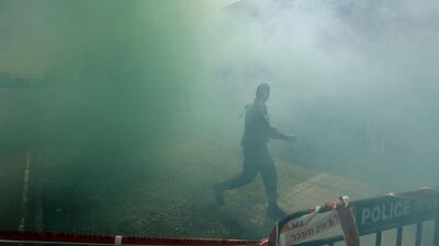 An Israeli soldier walks through smoke on February 24, 2014, during an emergency drill held at a girls school in Pisgat Zeev. The urban settlement is in an area Israel annexed to Jerusalem after capturing it in the 1967 Middle East war. Ammar Awad / Reuters