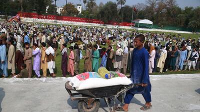 Afghan boys receive free rations distributed by the provincial government during the Muslim holy month of Ramadan amid a lockdown due to the ongoing coronavirus and COVID-19 pandemic, in Jalalabad, Afghanistan EPA