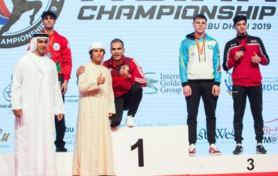 UAE's Ilyass Habibali, centre, after winning gold at the IFMA Asian Championship in Abu Dhabi. Ruel Pableo for The National