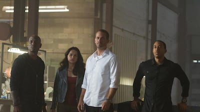 From left to right, Roman (TYRESE GIBSON), Letty (MICHELLE RODRIGUEZ), and Tej (CHRIS "LUDACRIS" BRIDGES) are back for Furious 7. Scott Garfield / Universal Pictures